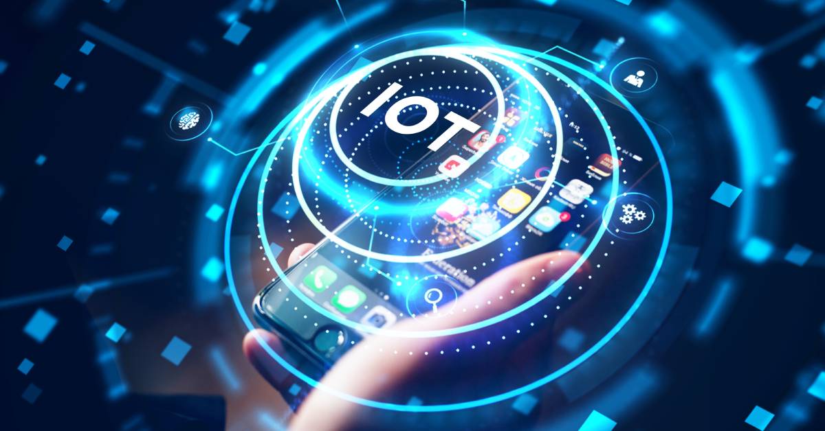 A person is using their personal cell phone to conveniently access "IoT" for connections to other devices.
