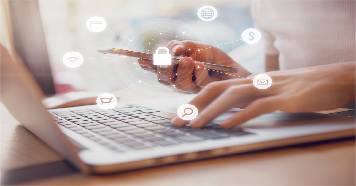 A close-up of a person using a laptop while holding a phone in one hand. Various ecommerce icons hover over the laptop.