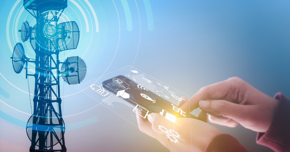 A cell tower off in the distance with a graphic over it. Someone holds a phone in their hands with various icons hovering over the phone.
