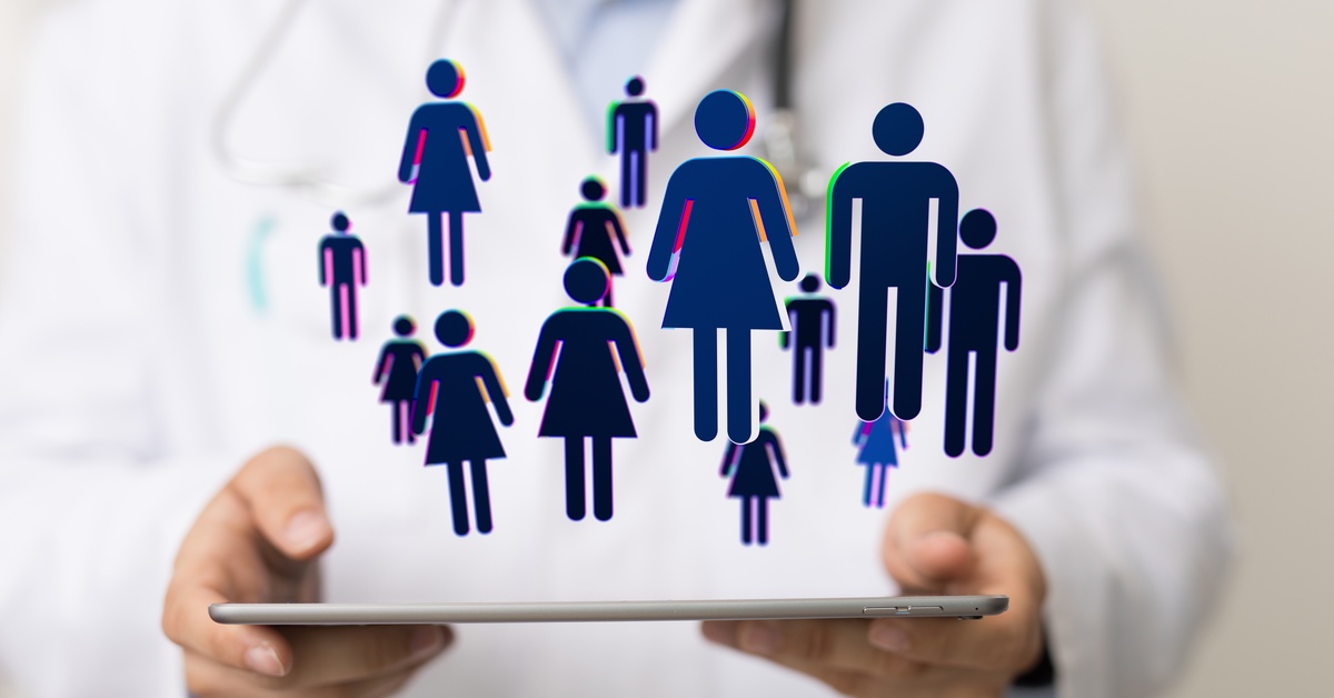 Three medical professionals crowded around a tablet. A graphic of stick people hovers over the tablet.