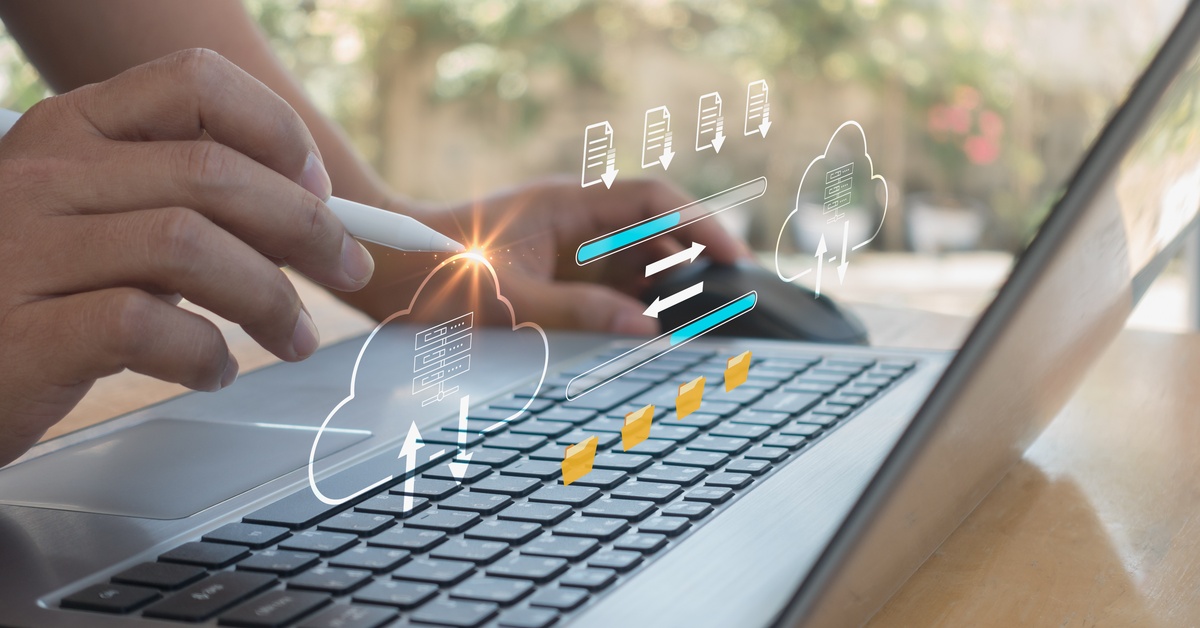A close-up of a person pointing a smart pen at a laptop screen with a file transfer graphic superimposed over it.